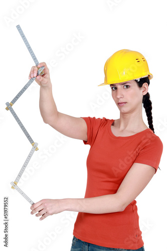 Photo: Construction worker holding a ruler Construction worker holding a ruler