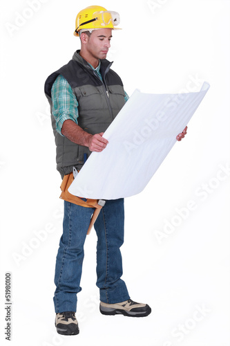 Photo: A foreman checking blueprints. A foreman checking blueprints.