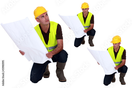 Photo: Multiple shot on foreman with plans kneeling Multiple shot on foreman with plans kneeling
