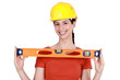 Brunette holding spirit-level