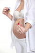 Photo: Pregnant woman showing pacifiers Pregnant woman showing pacifiers