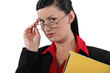 Clerical worker peering over her glasses