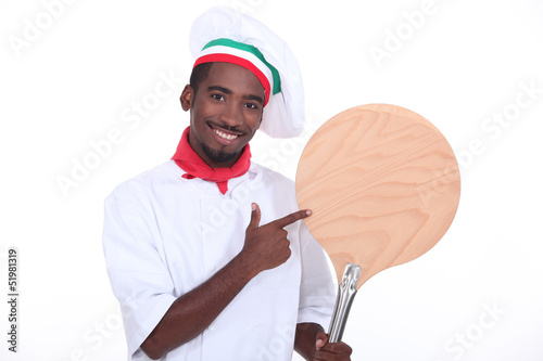 Photo: Pizza chef showing his pizza loading peel Pizza chef showing his pizza loading peel