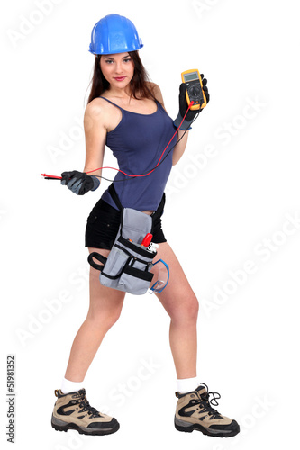 Photo: sexy female electrician holding a measurement tool sexy female electrician holding a measurement tool