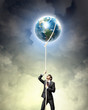 Image of businessman climbing rope
