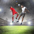 Foto: two football players striking the ball two football players striking the ball