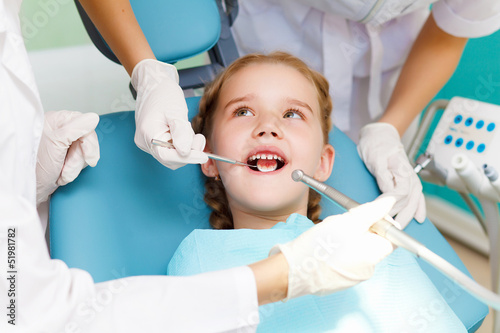 Photo: Little girl visiting dentist Little girl visiting dentist