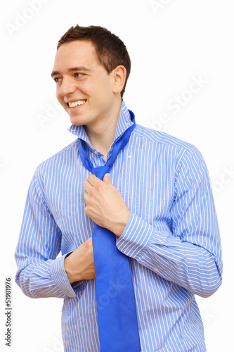 Photo: Businessman at home making his tie Businessman at home making his tie