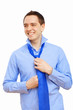 Businessman at home making his tie