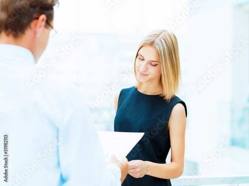 Photo: Two young business collegues. Two young business collegues.