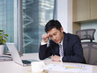 asian businessman thinking in office, frustrated