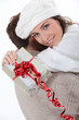 Couple hugging with gift in hand