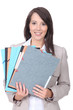 Photo: Female office worker with a pile of paperwork Female office worker with a pile of paperwork