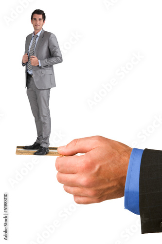 Photo: Businessman standing on someone else's credit card Businessman standing on someone else's credit card