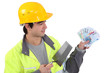 Young builder with a handful of cash