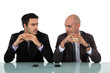 Photo: Two businessmen sat eating hanburgers Two businessmen sat eating hanburgers