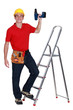 Construction worker with a drill
