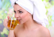 Beautiful young woman with cup of herbal tea