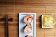 dish with fresh sushi rolls on bamboo napkin background