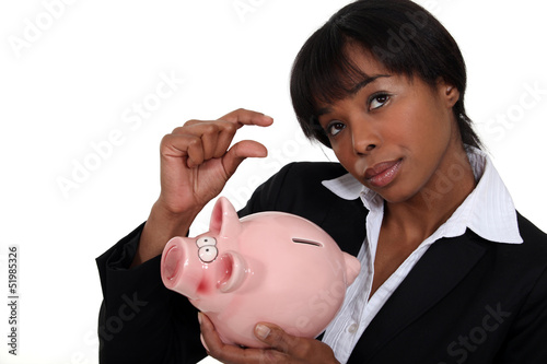 Photo: Businesswoman saving for a rainy day Businesswoman saving for a rainy day