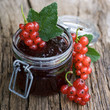 Photo: Redcurrant jam on wooden ground Redcurrant jam on wooden ground