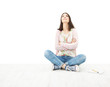 Foto: Beautiful girl teenager thinking sitting on white floor Beautiful girl teenager thinking sitting on white floor