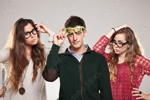 Photo: Three smart student friends looking with eyeglasses Three smart student friends looking with eyeglasses