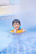 Boy learn to swim at hotel pool