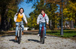 Urban biking - teens riding bikes in city park