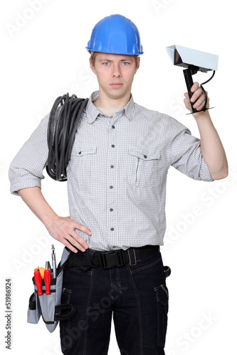 Photo: Electrician holding CCTV camera Electrician holding CCTV camera