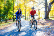 Urban biking - teens riding bikes in city park