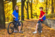 Urban biking - teens riding bikes in city park