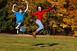 Girl and boy running, jumping in park