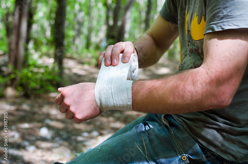 Photo: Applying an arm medical bandage Applying an arm medical bandage