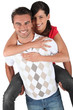 Man giving girlfriend piggyback