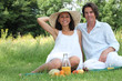 Couple sat in field