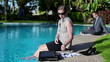 Businesswoman by the pool receiving bad news on the phone