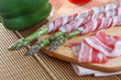 Bacon and asparagus on a wooden background
