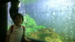 little boy posing near the aquarium