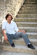 Photo: 35 years old man sitting on downstairs 35 years old man sitting on downstairs