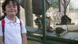 Little boy posing with racoon