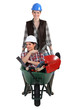 Woman being pushed in wheelbarrow