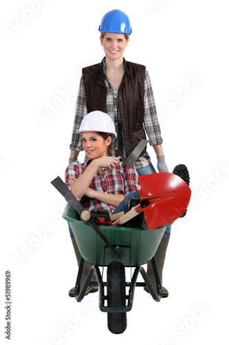 Photo: Woman being pushed in wheelbarrow Woman being pushed in wheelbarrow