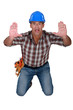 Photo: Scared construction worker with his hands up Scared construction worker with his hands up