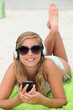 Photo: Girl listening to music on the beach Girl listening to music on the beach