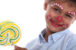 Boy made-up in clown with lollipop