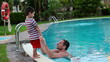 Video: Happy father in swimming pool talking to his son Happy father in swimming pool talking to his son