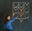 Thinking out of the box woman on blackboard background