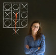 Thinking out of the box woman on blackboard background