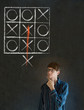 Thinking out of the box man on blackboard background